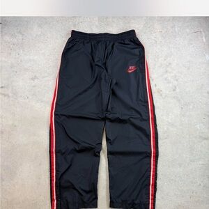 Nike Kids Black Joggers with Red Side Stripes